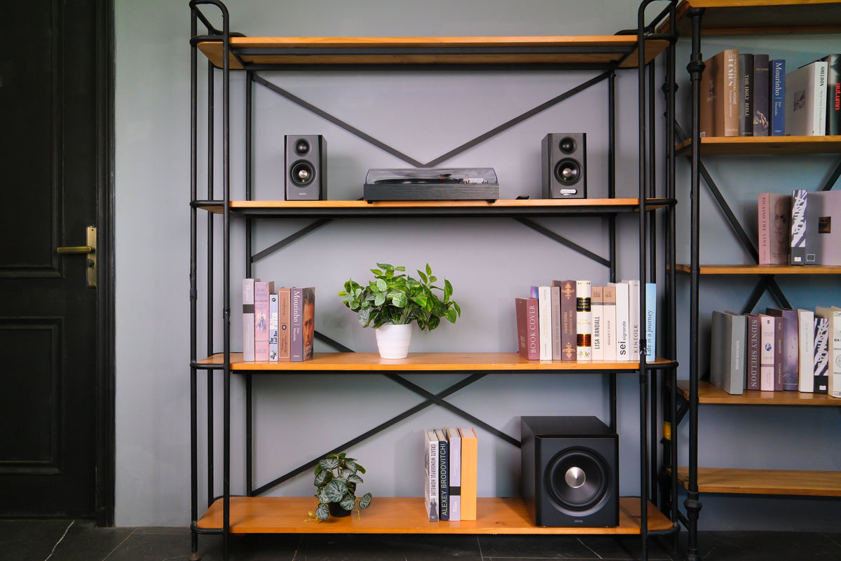 EDIFIER S355DB Walnut 2.1 speaker system on a media shelving unit