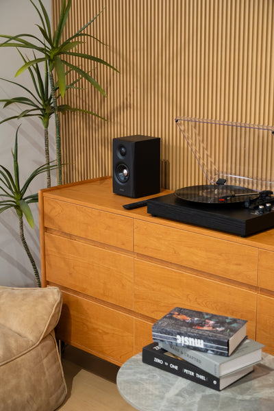 EDIFIER S355DB Black 2.1 speaker system beside a turntable and record collection