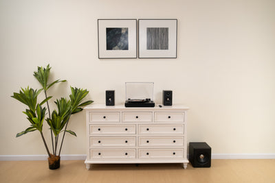 EDIFIER S355DB Black 2.1 speaker system with a turntable on a white sideboard