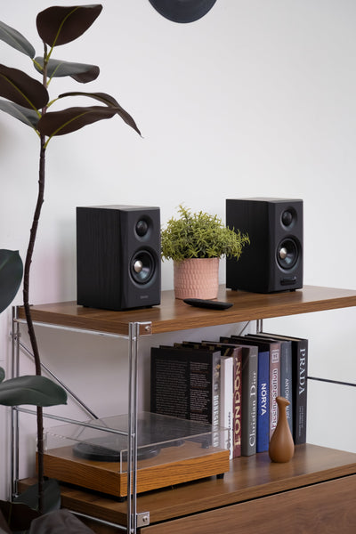 EDIFIER S355DB Black 2.1 speaker system satellite speakers on a media shelf