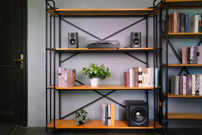 EDIFIER S355DB Walnut 2.1 speaker system on a media shelving unit