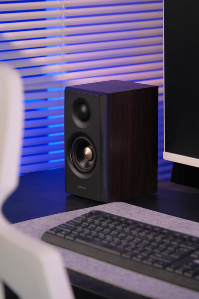 EDIFIER S355DB Walnut 2.1 speaker system satellite speaker beside a monitor