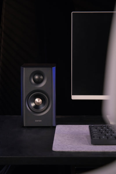 EDIFIER S355DB Walnut 2.1 speaker system satellite speaker front view in a gaming setup